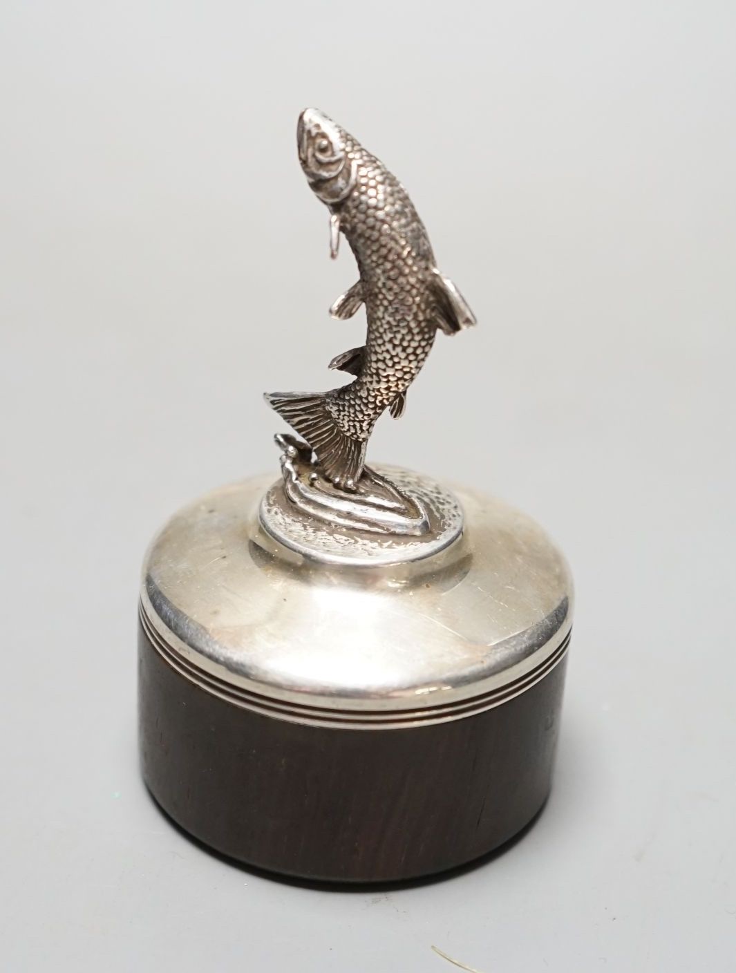A modern silver mounted wooden box and cover by Brian Leslie Fuller box, with leaping salmon finial, London, 1990, height 85mm.